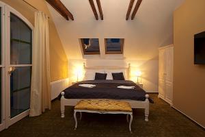 a bedroom with a large bed with two lamps at Old House in Hradec nad Moravici