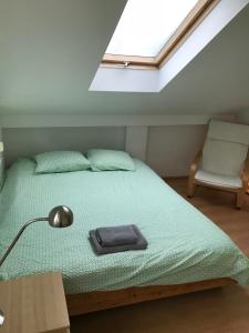 a bedroom with a bed with a lamp and a chair at House at Lake "Alte Donau" in Vienna in Vienna