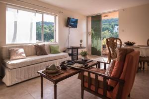 a living room with a couch and a table at Sunset Two Bedroom Suite At Turtle Towers in Ocho Rios