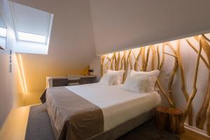 Een bed of bedden in een kamer bij Hotel Fabrica do Chocolate