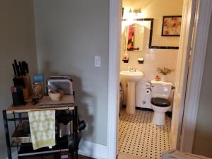a small bathroom with a toilet and a sink at Cozy Fully Furnished Apartment Near Prospect Park & Public Transport in Brooklyn