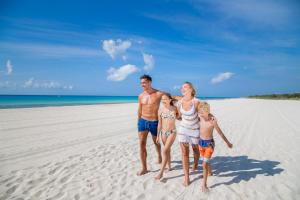 a family standing on the beach on the beach at Sandos Playacar All Inclusive in Playa del Carmen