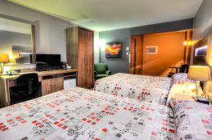 Un ou plusieurs lits dans un hébergement de l'établissement Hotel et Motel Le Chateauguay