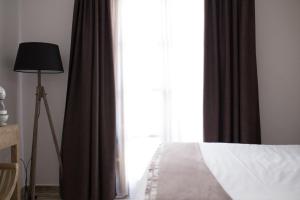 a bedroom with a bed and a large window at Hotel Abaco Altea in Altea