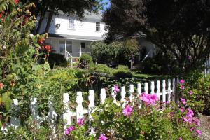 a white picket fence in front of a white house at Seagull Inn Bed & Breakfast in Mendocino