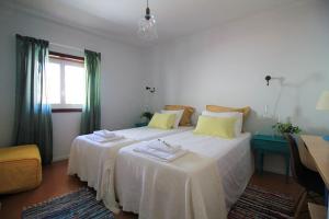 a bedroom with two beds and a window at Cabedelo Spot - Beachside Vacations in Viana do Castelo