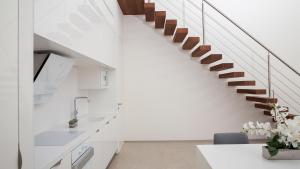 a staircase in a house with white walls at CARAIBAS Bonaire modern air-conditioned vacation home for architectural design lovers in Belnem