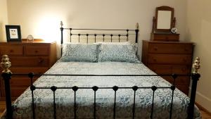 a bedroom with a bed and a dresser and a mirror at D2 at Watervale in Watervale