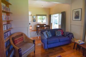 a living room with a couch and a chair at The Vicarage Martinborough in Martinborough