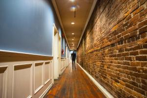 a hallway with a brick wall and a brick wall at The Cambie Hostel Gastown in Vancouver