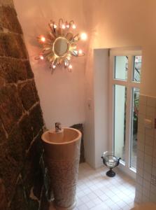 a bathroom with a sink and a mirror on the wall at Apartmenthaus Saxonia in Bad Schandau