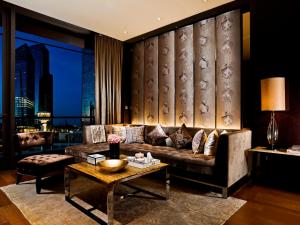 a living room with a couch and a table at The Fullerton Bay Hotel Singapore in Singapore