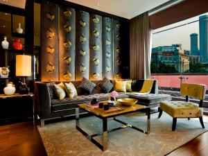 a living room with a couch and a table at The Fullerton Bay Hotel Singapore in Singapore