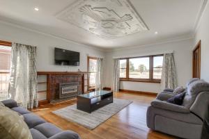 a living room with two couches and a fireplace at Seashells Lakes Entrance in Lakes Entrance