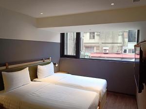 Ένα ή περισσότερα κρεβάτια σε δωμάτιο στο City Suites - Main Station
