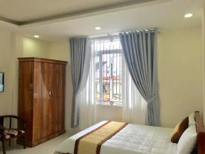 Postel nebo postele na pokoji v ubytování Mai Ngoc Hotel