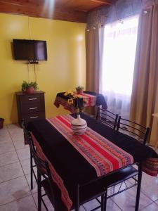 a dining room table with a table cloth on it at Departamento Luna Andina in San Pedro de Atacama