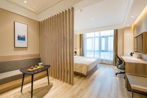 a hotel room with a bed and a desk at Atour Hotel (Nanjing Xingang Development Area) in Nanjing