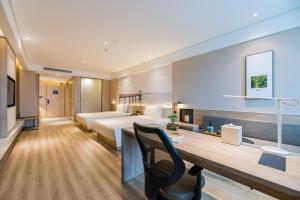 a hotel room with a bed and a desk at Atour Hotel (Nanjing Xingang Development Area) in Nanjing