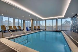 a swimming pool in a building with windows at Hyatt Place Iowa City Downtown in Iowa City