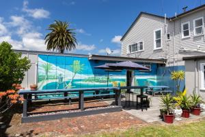 a patio with a table and an umbrella at Post Office Hotel in Foxton