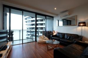 a living room with a couch and a table at ACD Apartments in Melbourne