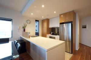 a kitchen with a white counter and a refrigerator at ACD Apartments in Melbourne