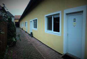 a row of houses with a door on the side at Petőfi Motel in Cristuru Secuiesc