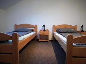 a room with two bunk beds and two night stands at Petőfi Motel in Cristuru Secuiesc