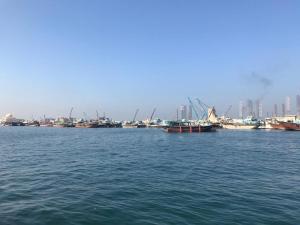 a group of boats in a large body of water at Al Majarah Residence in Sharjah