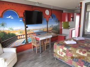 a hotel room with a mural of a balcony at Le George Motel in Port Macquarie