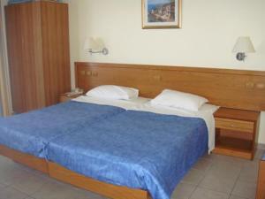Postel nebo postele na pokoji v ubytování Stella Hotel