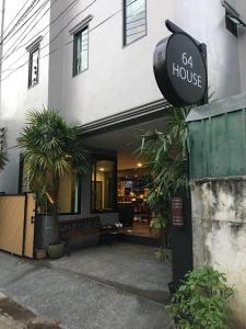 un bâtiment avec un panneau indiquant la maison dans l'établissement 64House, à Chiang Mai