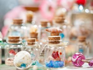 a table topped with glass jars filled with decorated eggs at Okinawa Kariyushi Beach Resort Ocean Spa in Onna +97 photos