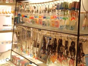 a display case in a store filled with lots of glasses at Okinawa Kariyushi Beach Resort Ocean Spa in Onna
