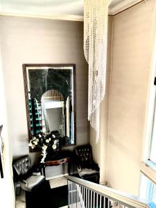 a living room with chairs and a mirror at Hotel Vandelli in Pavullo nel Frignano