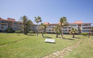 a park with a bench in front of a building at LUXURY GAVA BEACHFRONT APARTMENT BARCELONA in Gavà