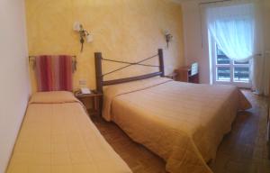 Llit o llits en una habitació de Hotel La Baita