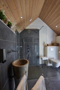 a bathroom with a shower with a tub and a toilet at Les Galets Blancs in Le Conquet