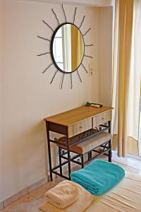 a mirror on the wall above a desk in a room at Vicky Studios in Myrina