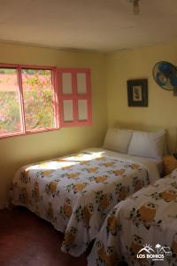 A bed or beds in a room at Los Bohios Campo Añil