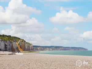 a beach with a rocky shore and cliffs at Dieppe Coeur de Ville in Dieppe