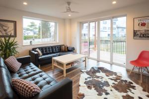 a living room with a couch and a table at Hakuba Downtown Apartments in Hakuba
