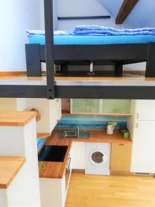 a small kitchen with a bunk bed in a room at Dimora Apartments with free parking in Ljubljana