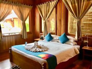 Postel nebo postele na pokoji v ubytování Inle Cottage Boutique Hotel