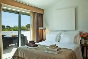 a hotel room with a bed with towels on it at Sao Rafael Holidays in Albufeira