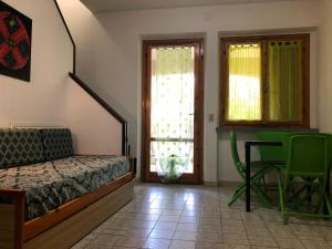 a bedroom with a bed and a table and chairs at Girino II in Principina a Mare