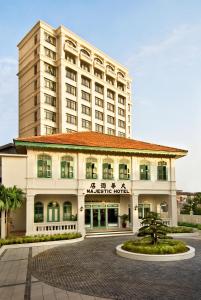 ein Hotel mit einem großen Gebäude im Hintergrund in der Unterkunft The Majestic Malacca Hotel - Small Luxury Hotels of the World in Malakka