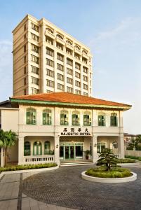 a hotel with a large building in the background at The Majestic Malacca Hotel - Small Luxury Hotels of the World in Malacca