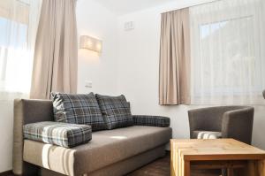 a living room with a couch and a chair at Bergruh Steeg in Steeg